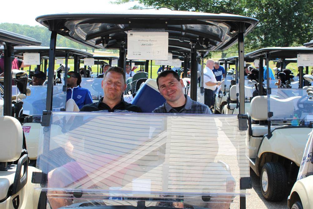 another 2 men in golf cart